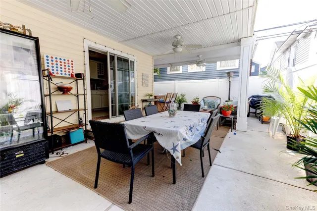 a outdoor dining space with furniture and wooden floor