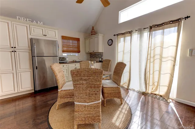 a dining room with furniture and wooden floor