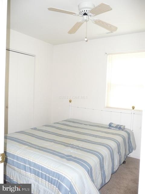30 Beaconhill Road Ocean Pines, MD 21811 - Photo 4 of 12 a bedroom with a bed and a chandelier