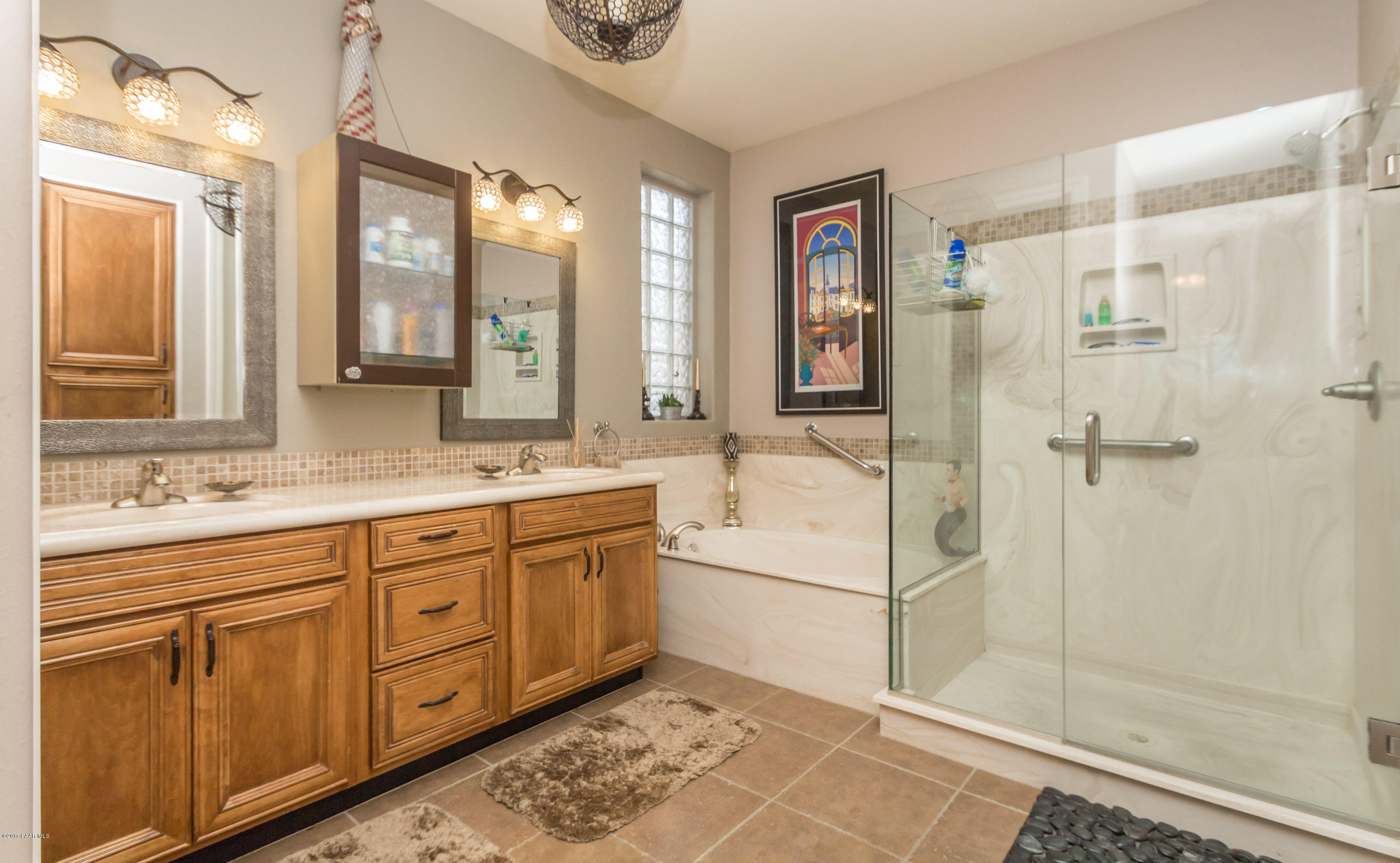 1256 Crown Ridge Drive Prescott, AZ 86301 - Photo 12 of 31 a bathroom with a granite countertop sink mirror and shower