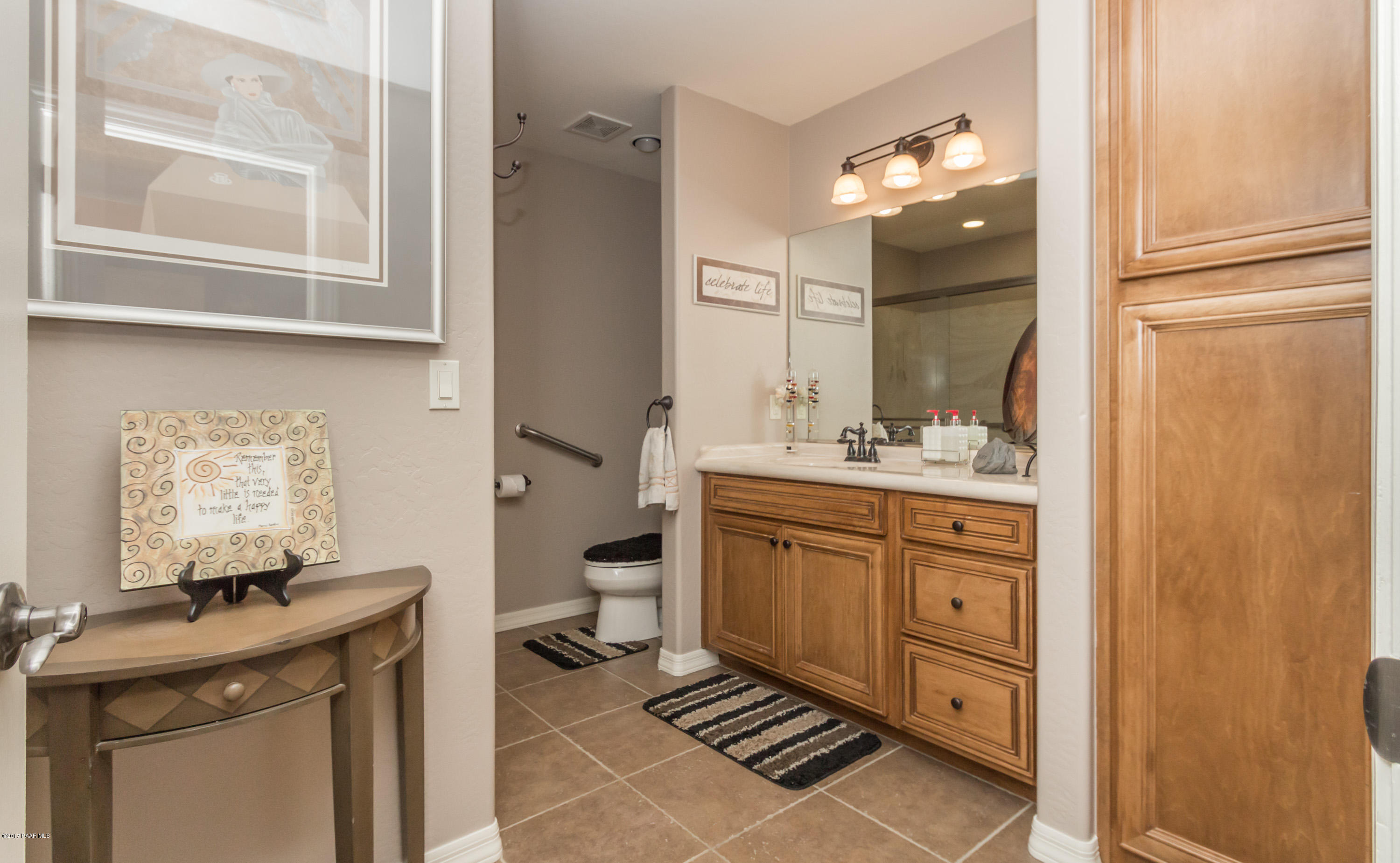 1256 Crown Ridge Drive Prescott, AZ 86301 - Photo 18 of 31 a spacious bathroom with a double vanity sink a mirror and a toilet