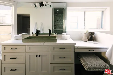 a bedroom with bed and mirror