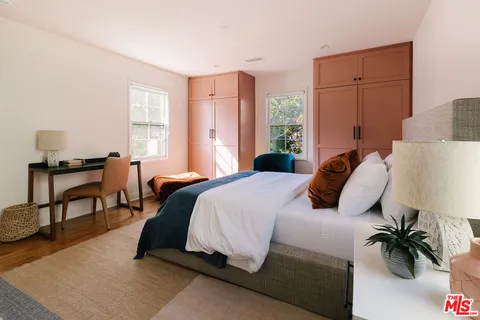 a living room with furniture and a mirror