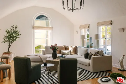 a living room with furniture fireplace and a window