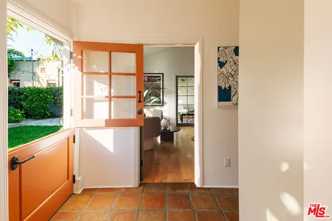 a front view of a house with a garden and plants