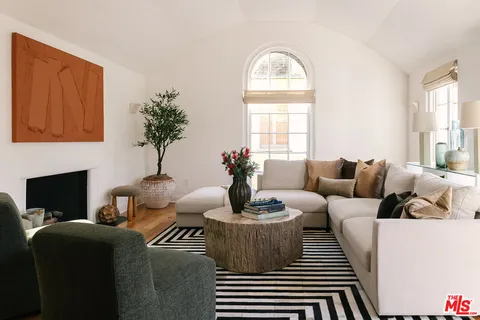 a living room with furniture and a potted plant