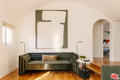 a view of a livingroom with furniture and a mirror