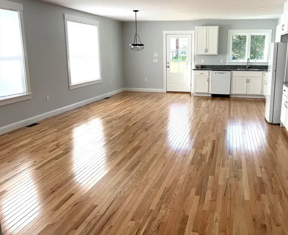 a view of a kitchen counter space wooden floor and a window