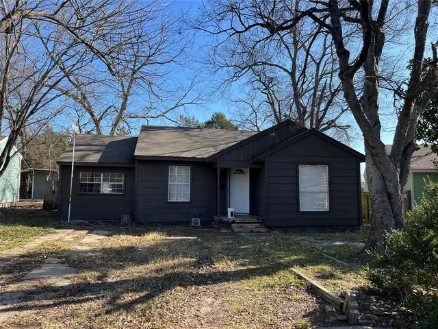 a house that has a tree in front of it