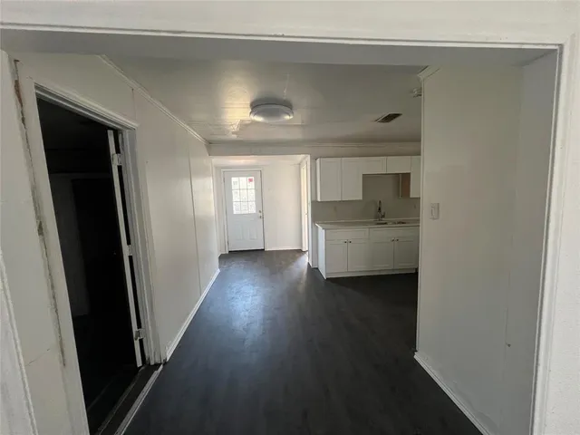 a kitchen with granite countertop white cabinets and stainless steel appliances