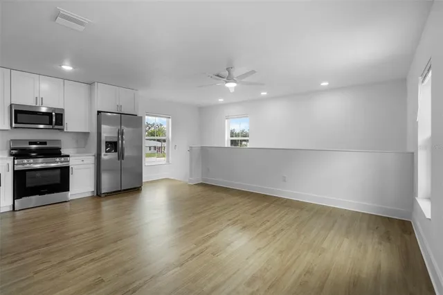 a view of a kitchen with a sink and a stove top oven