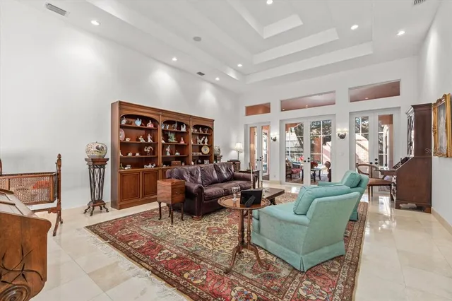 a kitchen with kitchen island a counter space a sink and a large window
