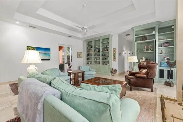 a kitchen with kitchen island a counter space a sink and a large window