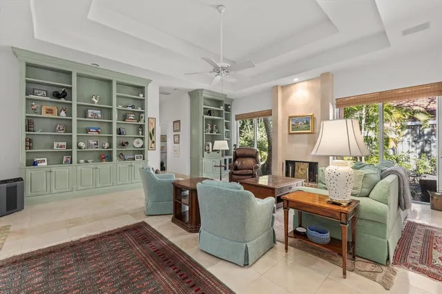 a kitchen with stainless steel appliances kitchen island granite countertop a stove a sink a dining table and chairs with cabinets