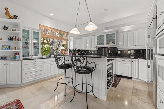 a bathroom with a double vanity sink toilet and shower