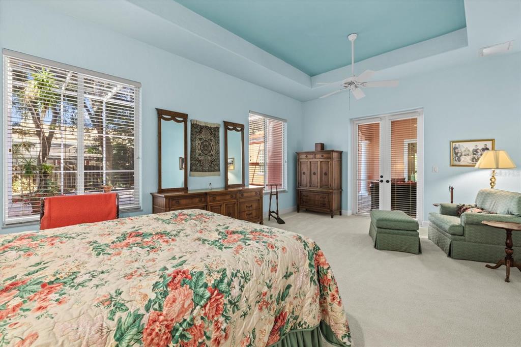 4939 Peregrine Point Way Sarasota, FL 34231 - Photo 28 of 57 a bedroom with a bed and glass top table