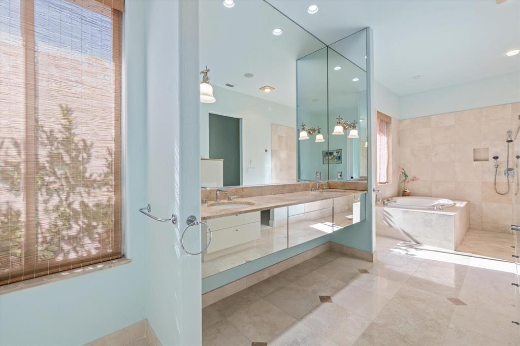 4939 Peregrine Point Way Sarasota, FL 34231 - Photo 29 of 57 a bathroom with a double vanity sink toilet and shower