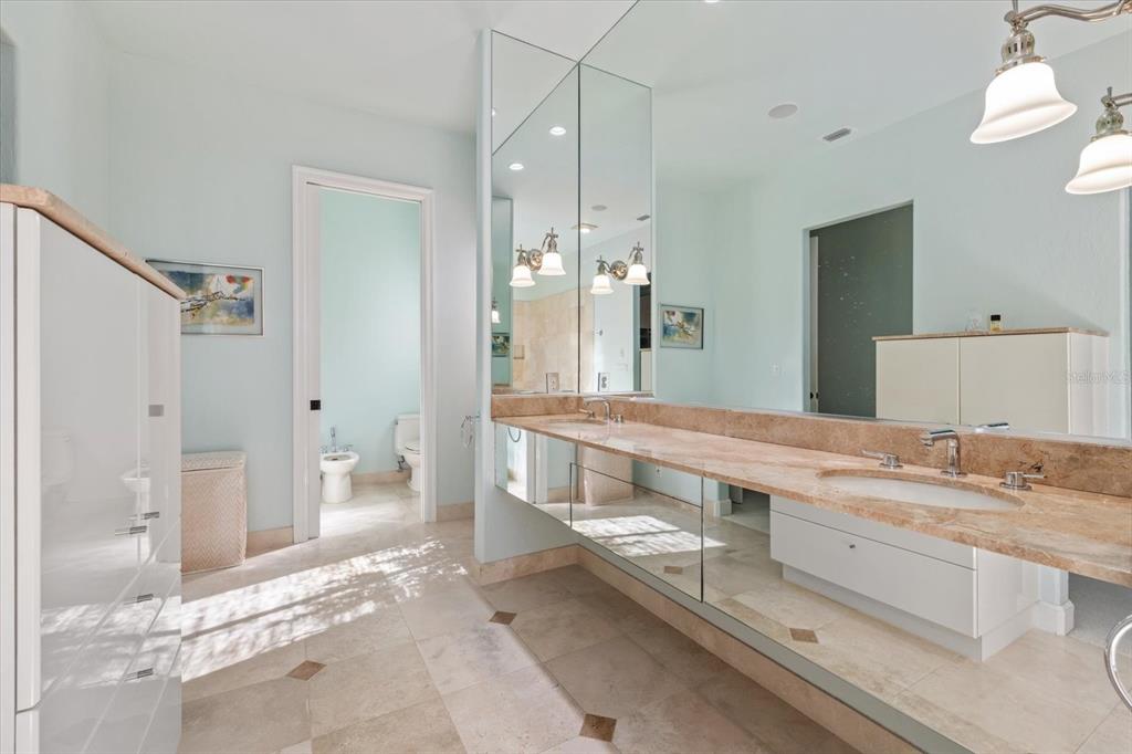 4939 Peregrine Point Way Sarasota, FL 34231 - Photo 30 of 57 a spacious bathroom with a double vanity sink mirror and shower