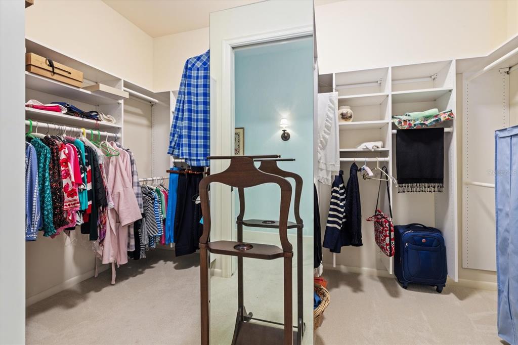 4939 Peregrine Point Way Sarasota, FL 34231 - Photo 32 of 57 a view of walk in closet with clothes and shoes