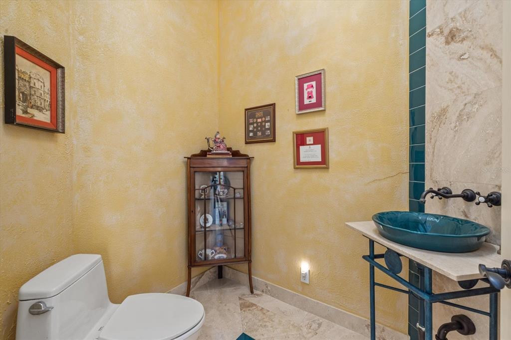 4939 Peregrine Point Way Sarasota, FL 34231 - Photo 34 of 57 a bathroom with a toilet a sink and a shower curtain