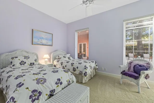 a living room with furniture a rug and a large window
