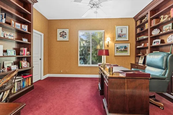 a living room with furniture a rug and a large window