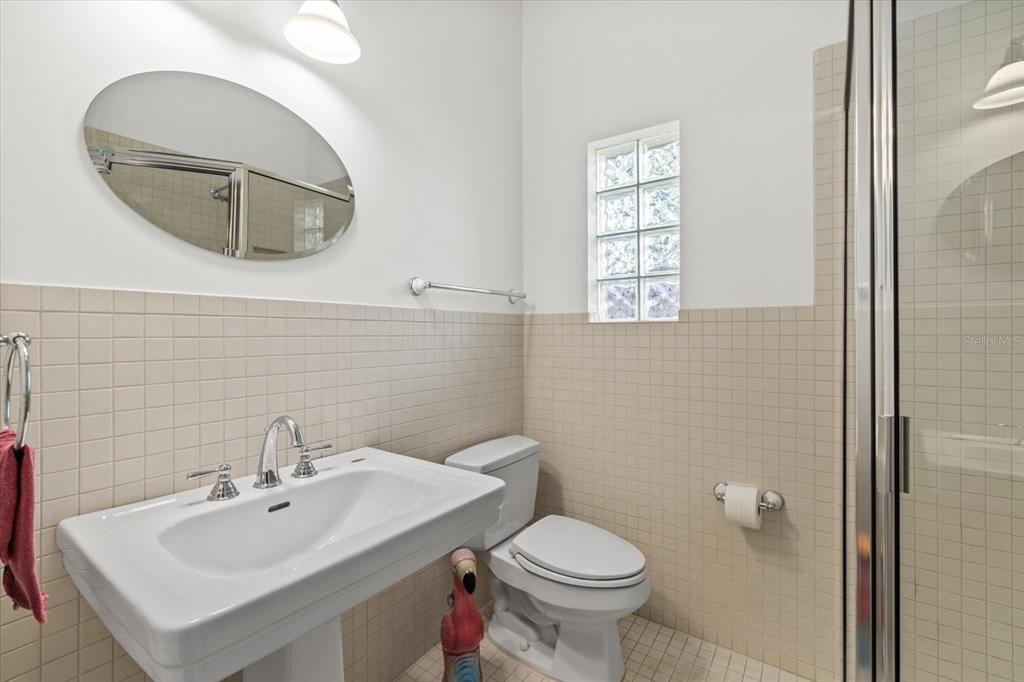 4939 Peregrine Point Way Sarasota, FL 34231 - Photo 44 of 57 a bathroom with a sink a mirror and a toilet