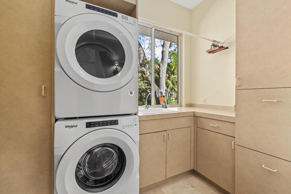 4939 Peregrine Point Way Sarasota, FL 34231 - Photo 45 of 57 a utility room with dryer and washer