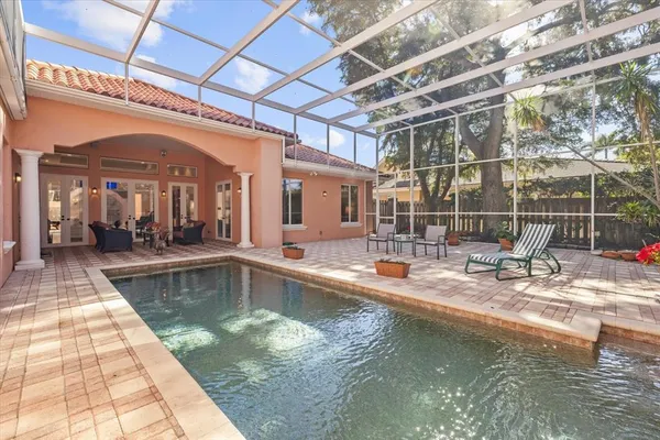 a view of a swimming pool with a glass door and chair