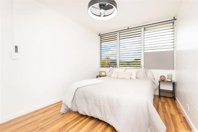 a bedroom with a bed and a large window