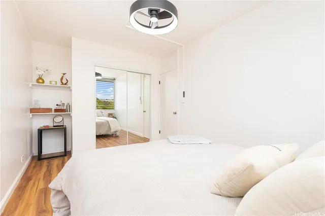 a bedroom with a bed and a lamp