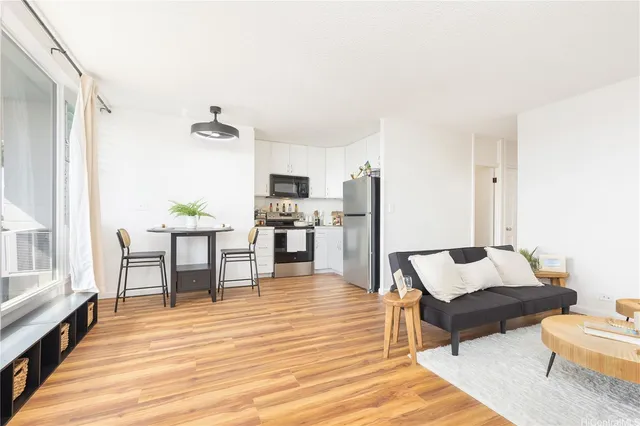 a living room with furniture and a wooden floor