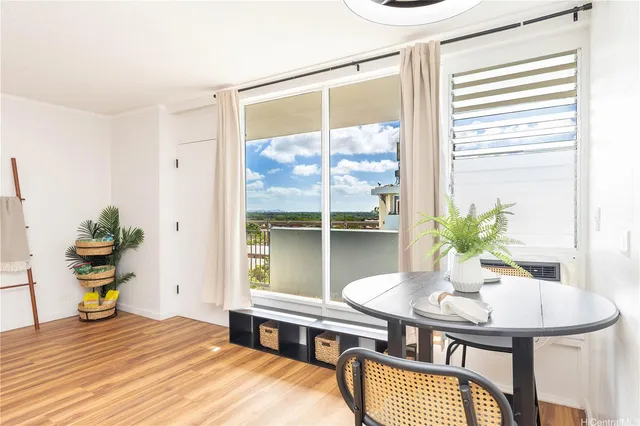 a view of a dining room with a table and chairs