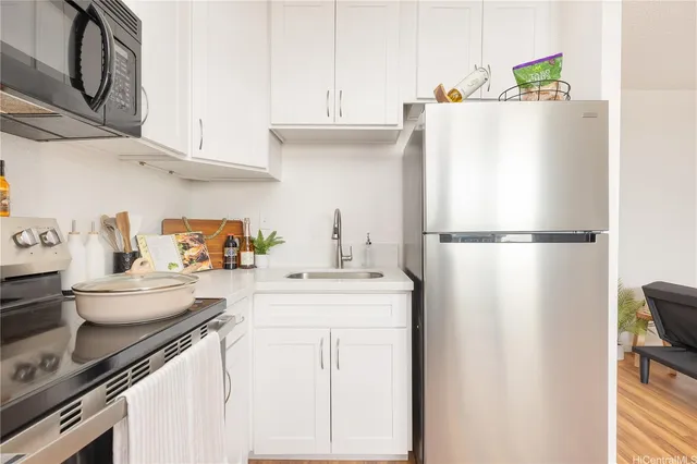 a kitchen with a refrigerator and a sink