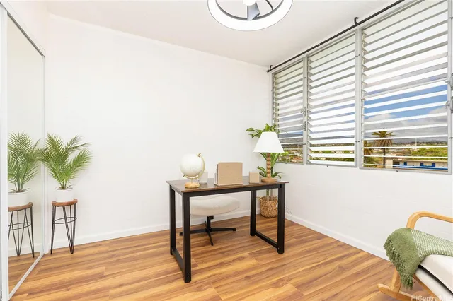 a view of a workspace with furniture and a potted plant