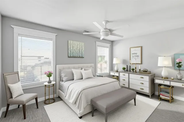 a spacious bedroom with a bed a couch and a window