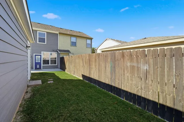 a view of a back yard of the house with a street