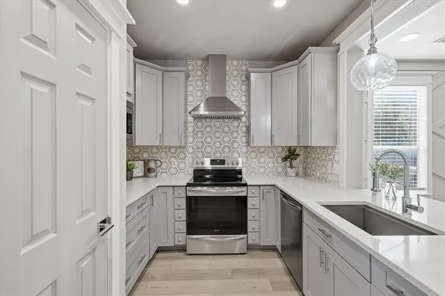 a kitchen with stainless steel appliances a stove sink and cabinets