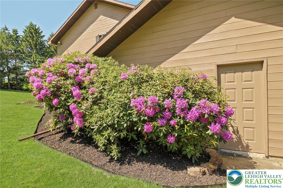 3470 Brodhead Road Bethlehem, PA 18020 - Photo 79 of 84 Flourishing rhododendrons frame the exterior, adding vibrant color to the neatly landscaped grounds.