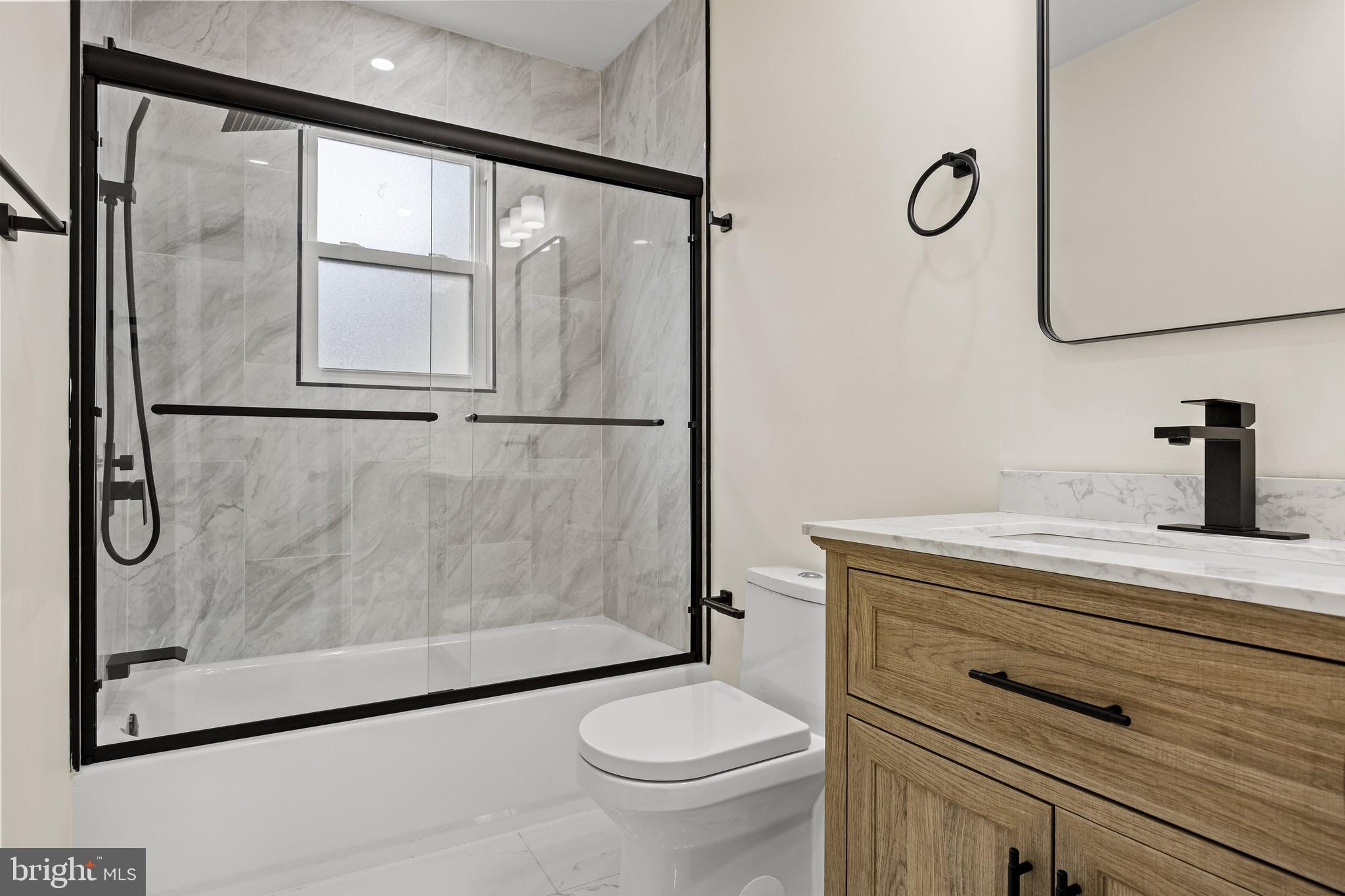 937 Clements Bridge Road Barrington, NJ 08007 - Photo 27 of 34 a bathroom with a granite countertop sink mirror vanity and toilet