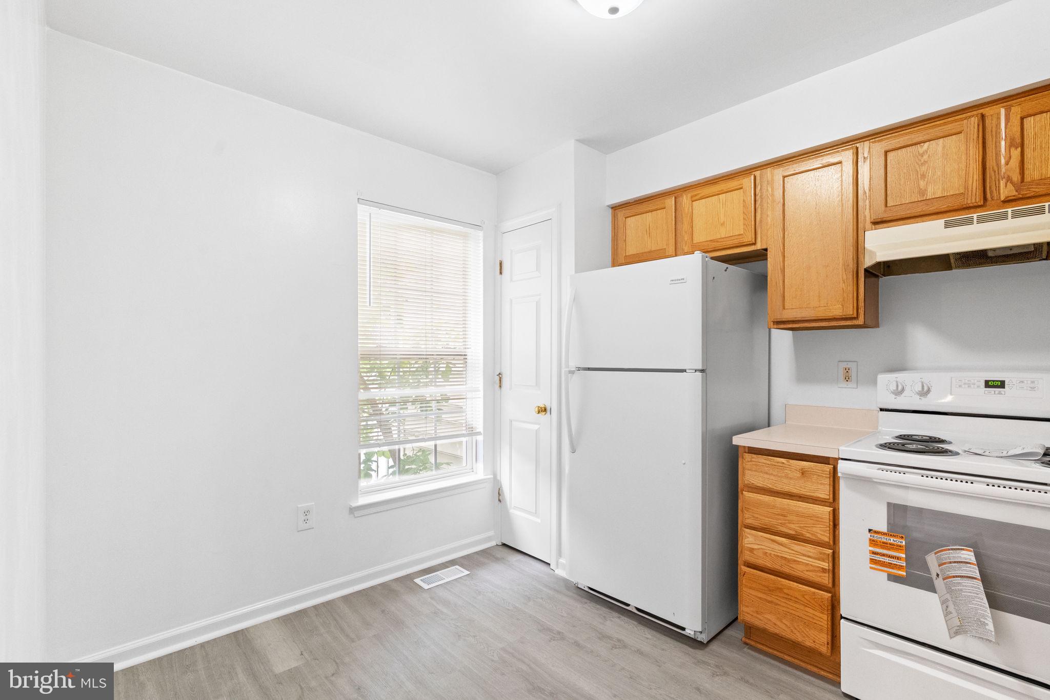 1703 Orchard View Road Reading, PA 19606 - Photo 12 of 53 a kitchen with a refrigerator a stove top oven and cabinets