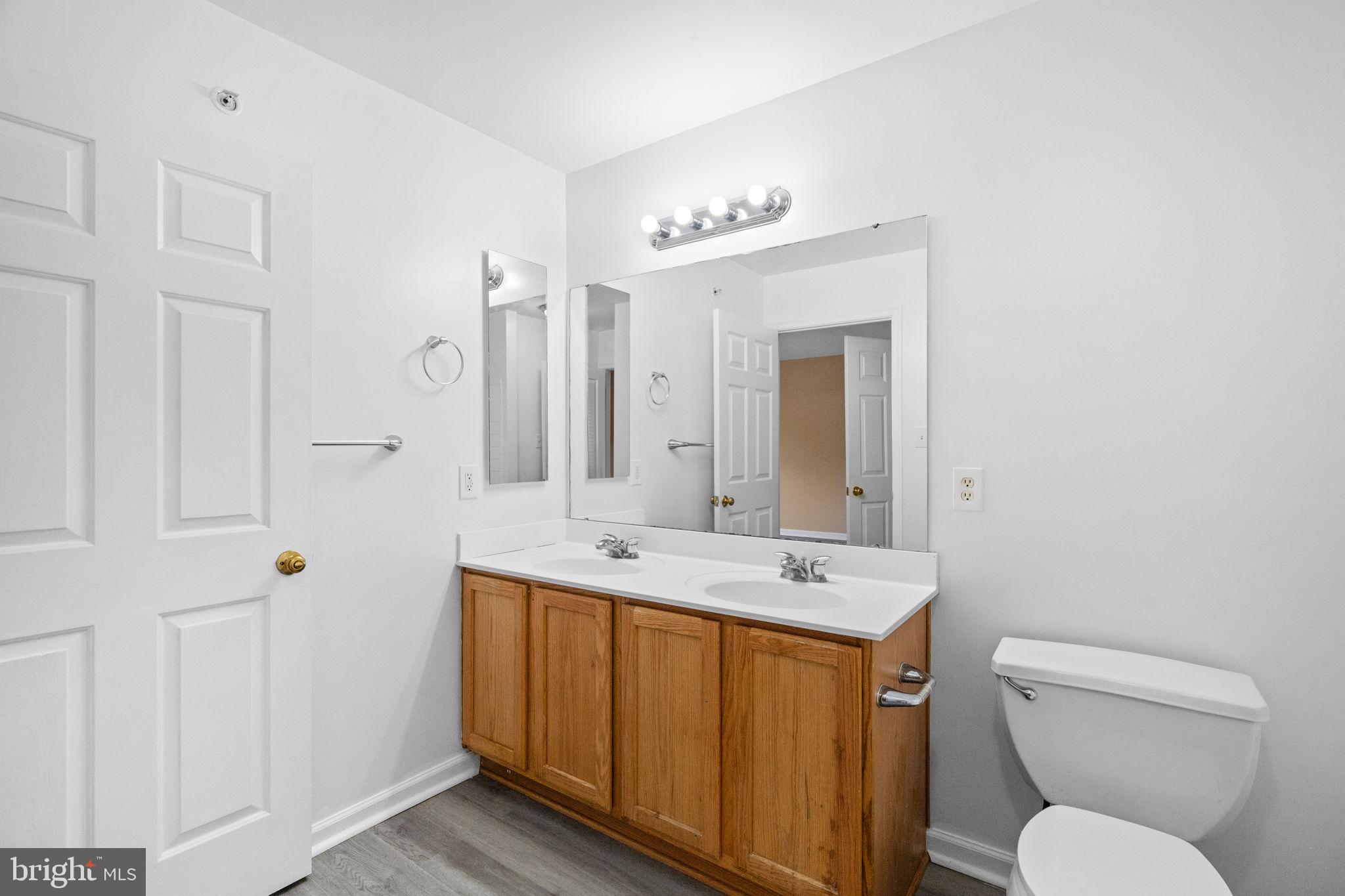 1703 Orchard View Road Reading, PA 19606 - Photo 14 of 53 a spacious bathroom with a toilet sink and mirror