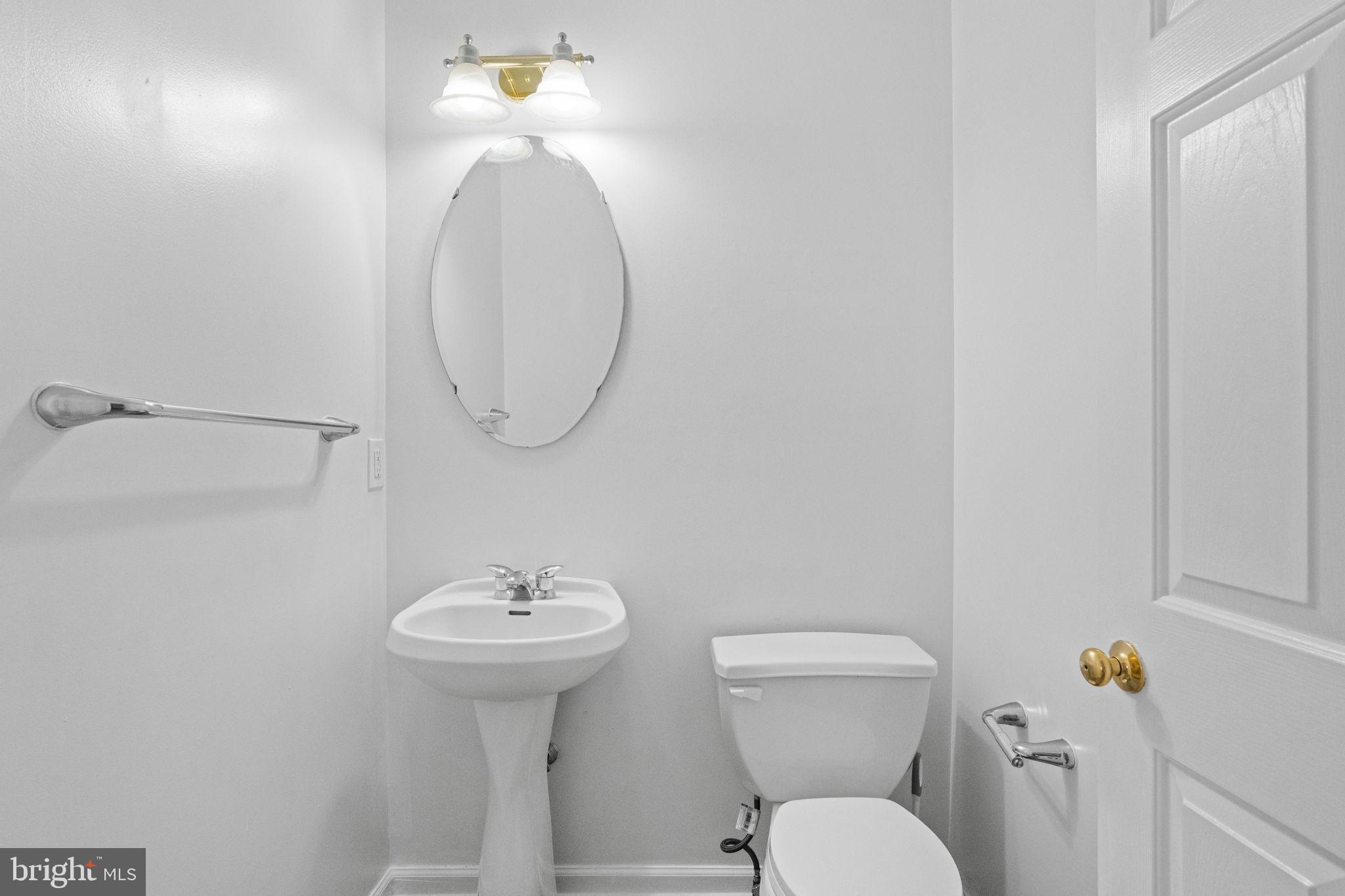 1703 Orchard View Road Reading, PA 19606 - Photo 15 of 53 a bathroom with a toilet a sink and a mirror
