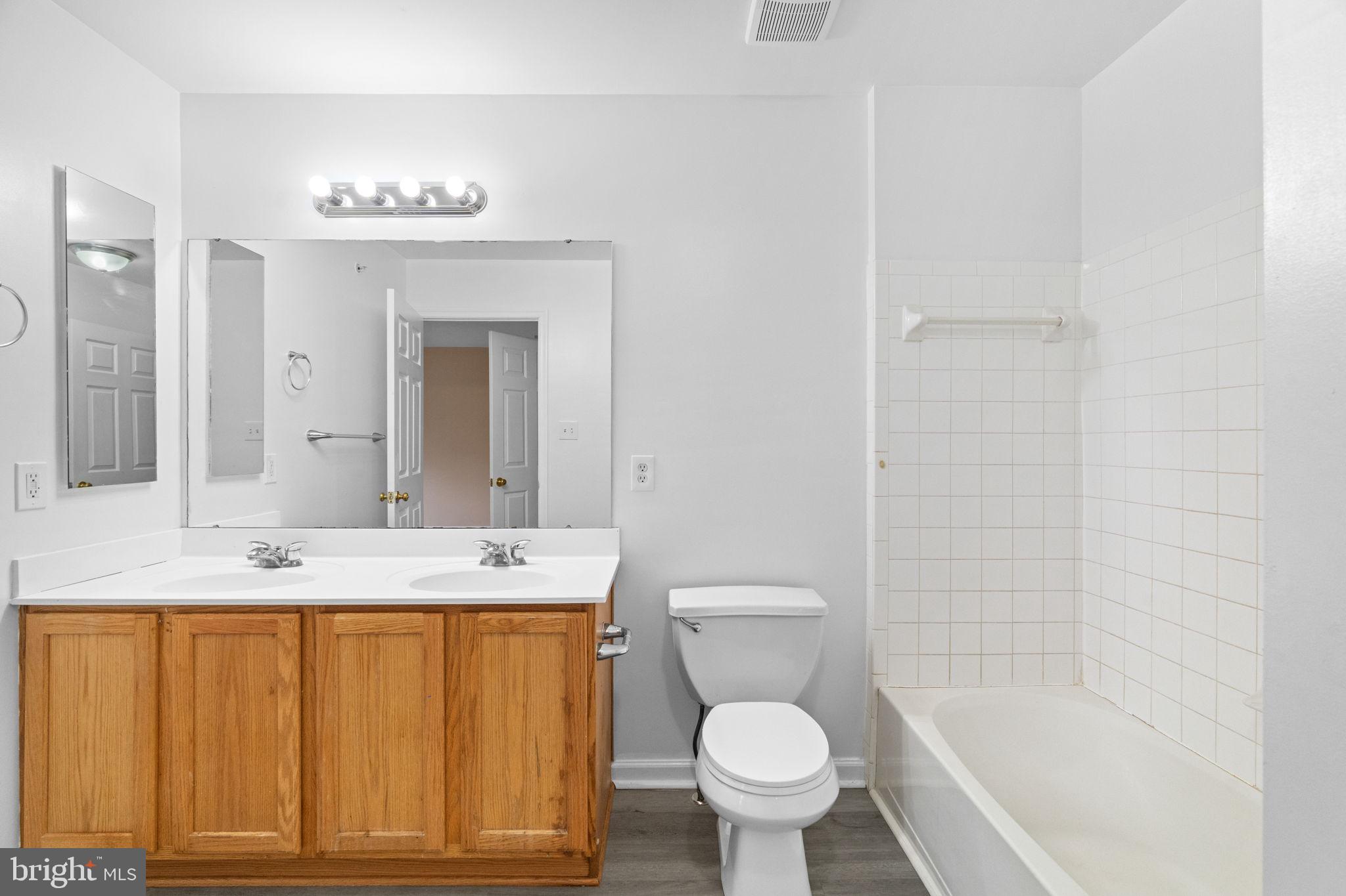 1703 Orchard View Road Reading, PA 19606 - Photo 16 of 53 a bathroom with a sink a toilet a mirror and shower