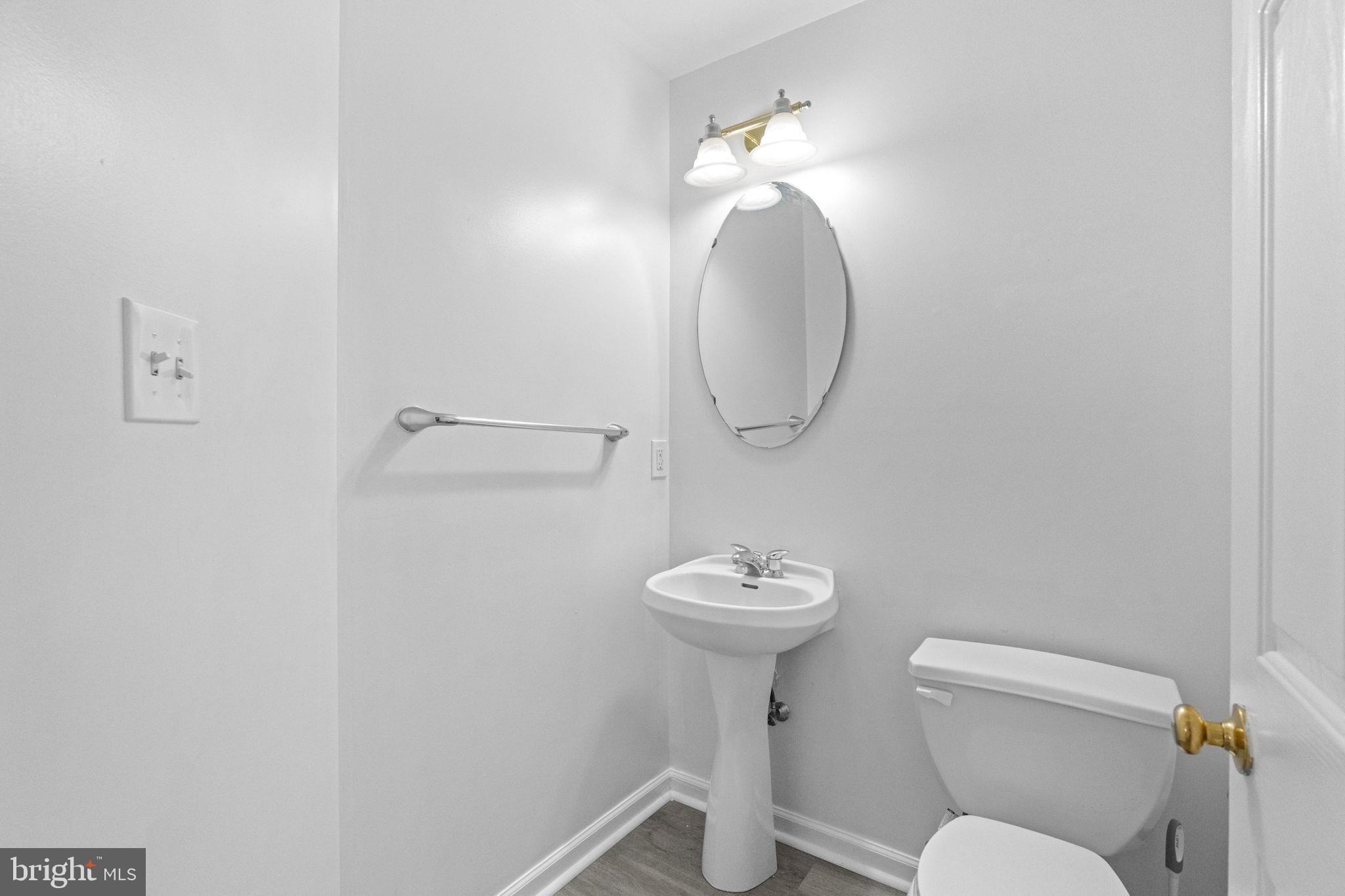1703 Orchard View Road Reading, PA 19606 - Photo 17 of 53 a bathroom with a toilet sink and mirror