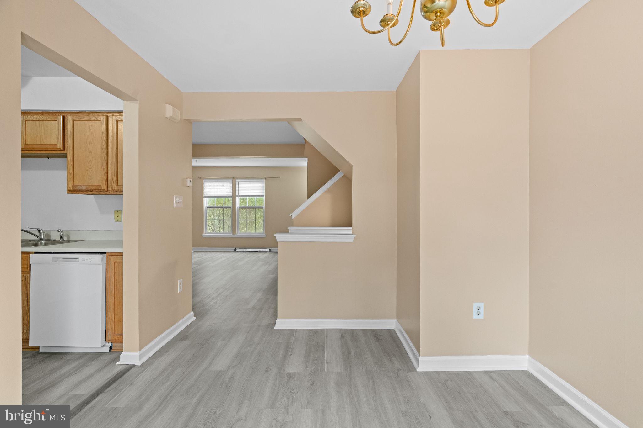1703 Orchard View Road Reading, PA 19606 - Photo 21 of 53 an empty room with wooden floor and a kitchen