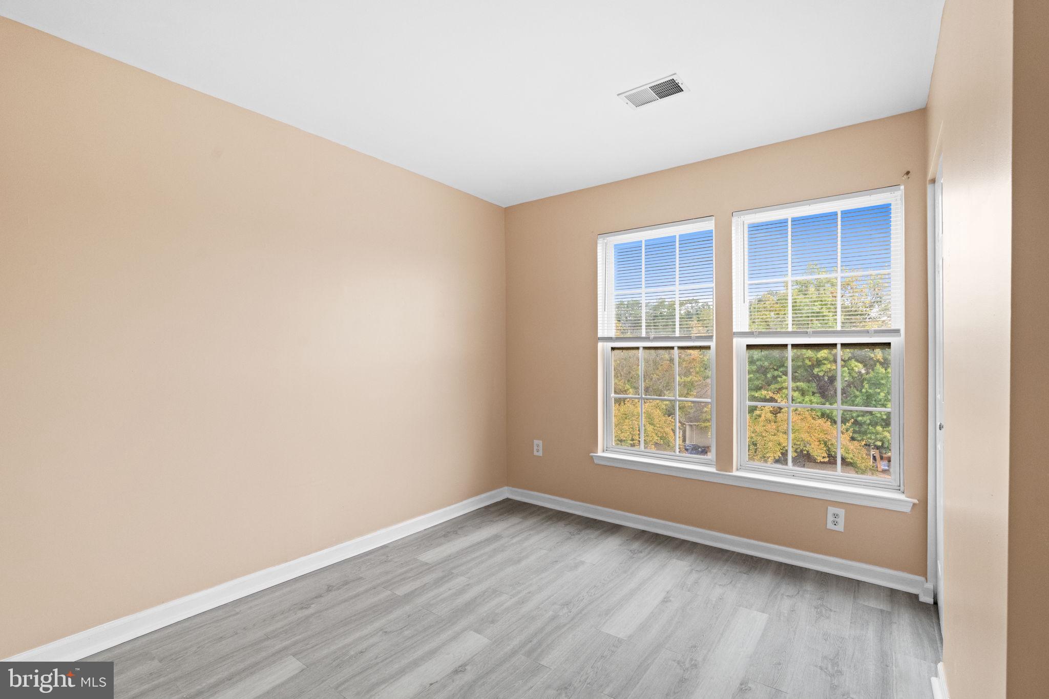 1703 Orchard View Road Reading, PA 19606 - Photo 22 of 53 an empty room with wooden floor and windows