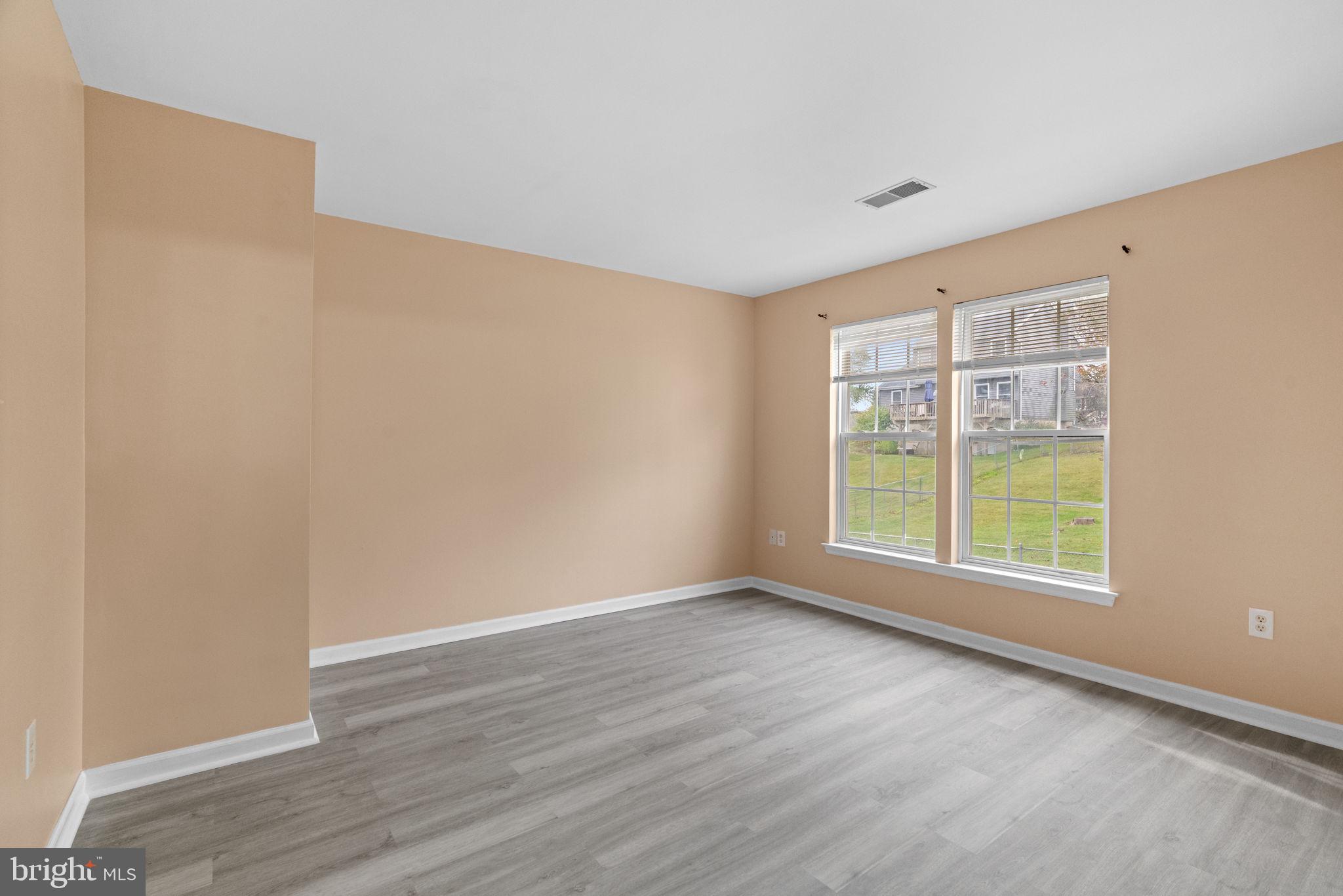 1703 Orchard View Road Reading, PA 19606 - Photo 30 of 53 a view of an empty room with wooden floor and a window