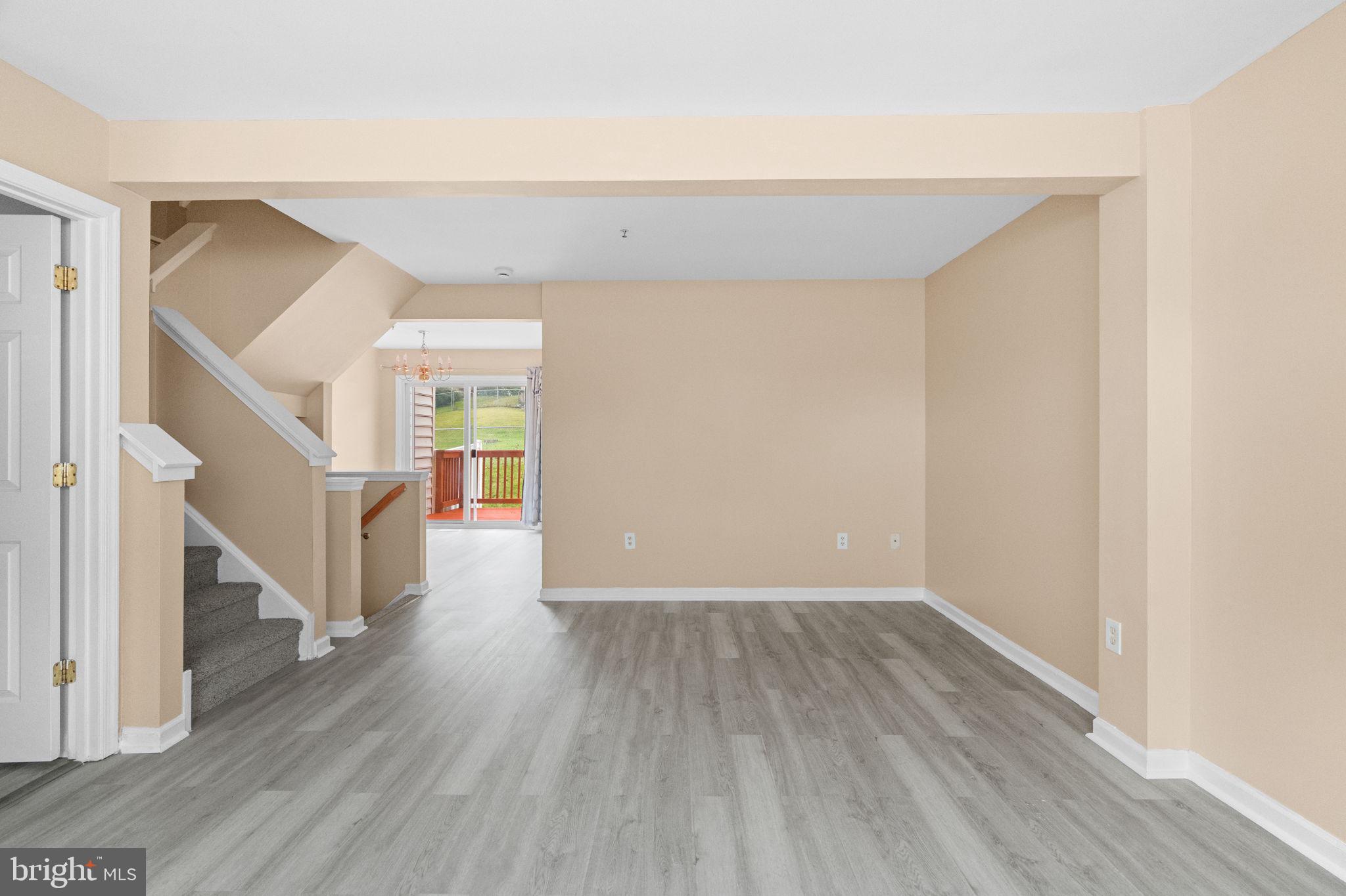 1703 Orchard View Road Reading, PA 19606 - Photo 6 of 53 a view of an empty room with wooden floor and stairs