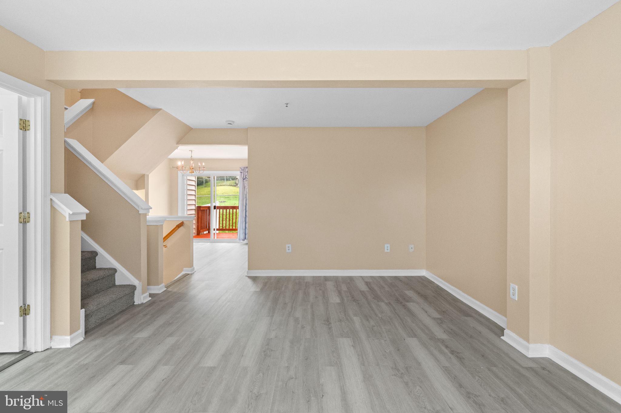 1703 Orchard View Road Reading, PA 19606 - Photo 7 of 53 a view of an empty room with wooden floor and a window